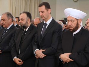 Syria’s President Bashar al-Assad (2nd R) performs prayers for Eid al-Adha, at al-Afram Mosque in al-Muhajirin area in Damascus October 26, 2012, in this handout photograph released by Syria’s national news agency SANA (SANA/Reuters).