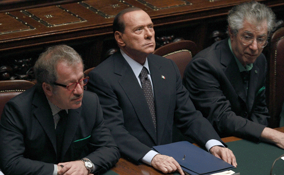 Italian Prime Minister Silvio Berlusconi (C) looks on next Justice Minister Roberto Maroni (R) and League North Party leader Umberto Bossi during a finance vote at the parliament in Rome November 8, 2011