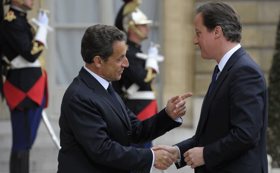 France’s President Nicolas Sarkozy (L) greets Britain’s Prime Minister David Cameron at the Elysee Palace in Paris on April 13, 2011