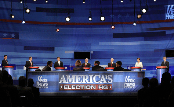 Republican presidential candidates (L-R), former Pennsylvania Sen. Rick Santorum, Texas Gov. Rick Perry, former Massachusetts Gov. Mitt Romney, former House Speaker Newt Gingrich, Rep. Ron Paul (R-TX), Rep. Michele Bachmann (R-MN), and former Utah Gov. Jon Huntsman participate in a Republican presidential debate in Sioux City, Iowa, December 15, 2011. 