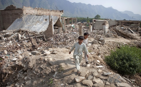Boys walk through the rubble of destroyed homes in Buner, Pakistan on September 14, 2009.