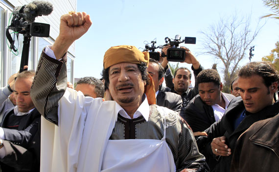 Muammar Qaddafi waves in Tripoli before making a speech