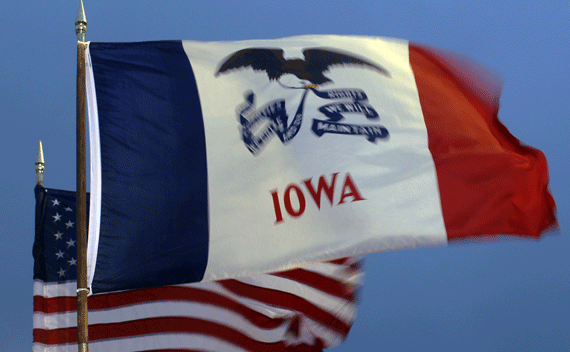 The U.S. and Iowa state flags fly at a rally with Republican presidential candidate and former Massachusetts Governor Mitt Romney in West Des Moines, Iowa December 30, 2011, ahead of the Iowa Caucus on January 3, 2012. REUTERS/Brian Snyder (UNITED STATES - Tags: POLITICS)