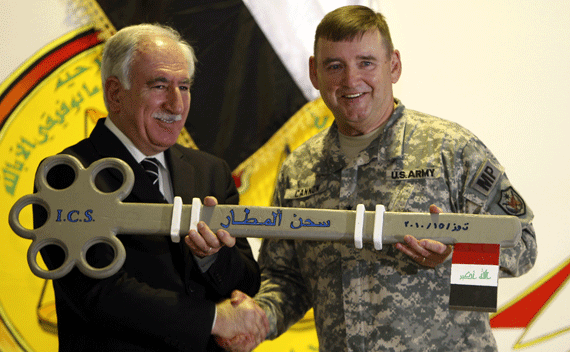U.S. Major General Jerry Cannon (R) dedicates a giant key to Iraq’s Justice Minister Dara Noor-Eldeen as a symbolic gesture during a ceremony marking the transfer of Camp Cropper, the last U.S. detention centre in Iraq, to the Iraqi government in Baghdad July 15, 2010. REUTERS/Saad Shalash