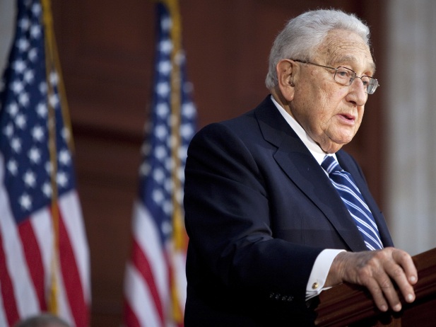 Former U.S. secretary of state Henry Kissinger delivers a speech in front of a picture of late U.S. president Richard Nixon meeting with late premier Zhou Enlai during a ceremony in Shanghai to commemorate the 30th anniversary of the 