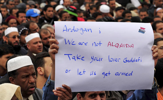 Man holds a sign during prayers in Benghazi on April 1, 2011. 