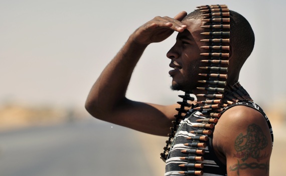 A Libyan rebel stands guard near the entrance of Ras Lanuf on August 27, 2011 (Esam Al-Fetori/Courtesy Reuters).