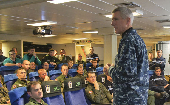 U.S. Admiral Locklear speaks with an aircrew from the French Navy aircraft carrier Charles de Gaulle operating in Mediterranean Sea on March 21, 2011.