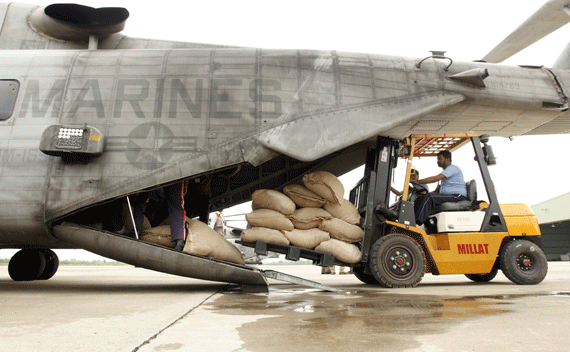Workers load bags of flour for flood victim relief onto a U.S. Marine helipcopter in northwest Pakistan on August 16, 2010. 