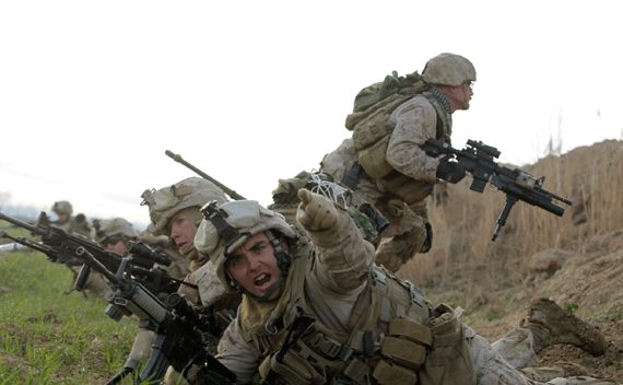 A U.S. Marine from Bravo Company of 1st Battalion, 6th Marines, gestures during a gun battle in Helmand province. (Goran Tomasevic/courtesy Reuters)