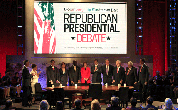 Republican presidential hopefuls (L-R) former Utah Governor Jon Huntsman, U.S. Rep. Michele Bachmann (R-MN), Texas Gov. Rick Perry, Bloomberg reporter Julianna Goldman, businessman Herman Cain, Karen Tumulty of the Washington Post, former Massachusetts Governor Mitt Romney, host Charlie Rose, U.S. Rep. Ron Paul (R-TX), former Pennslyvania Senator Rick Santorum (R-PA) and former Speaker of the U.S. House of Representatives Newt Gingrich (R-GA) gather prior to participatin in a debate at Dartmouth College in Hanover, New Hampshire October 11, 2011. REUTERS/Adam Hunger 