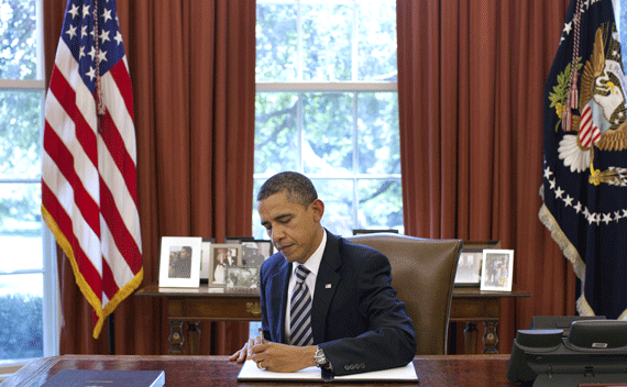 President Barack Obama signs the Budget Control Act of 2011 in the Oval Office at the White House in Washington, August 2, 2011.
