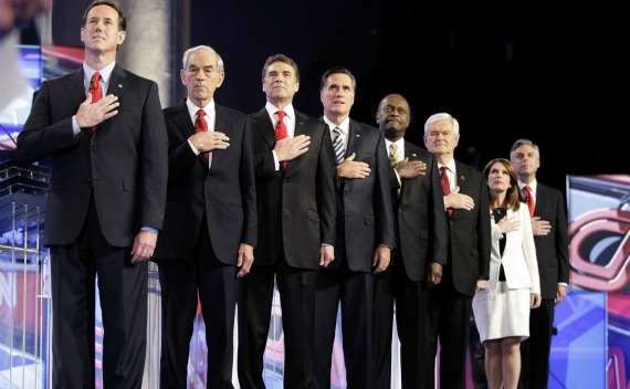 Republican presidential candidates stand at attentiond during the singing of the national anthem during the CNN GOP National Security debate on November 22, 2011.