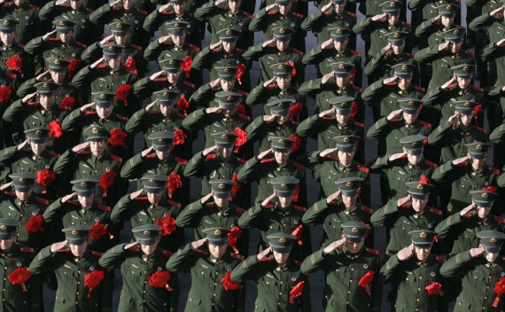 Chinese policemen salute during a ceremony in Shanxi province.