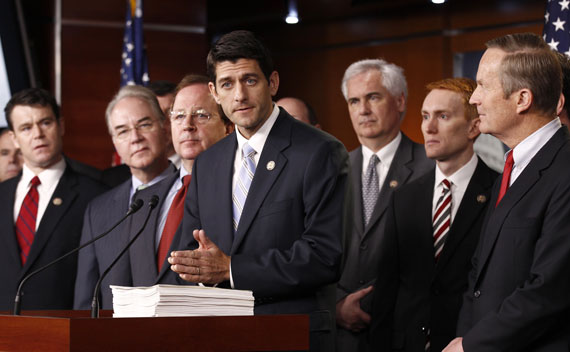 Standing with fellow Republican House members, House Budget Committee Chairman Paul Ryan (R-WI) speaks at a news conference held to unveil the House Republican budget blueprint in the Capitol in Washington