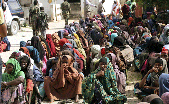 Internally displaced women wait to receive food aid from Saudi Arabia in Badbaado settlement camp in Somalia’s capital Mogadishu, August 17, 2011. Somalia called for the creation of a new force to protect food aid convoys and camps in the famine-hit country, and declared a state of emergency in parts of Mogadishu. REUTERS/Omar Faruk 