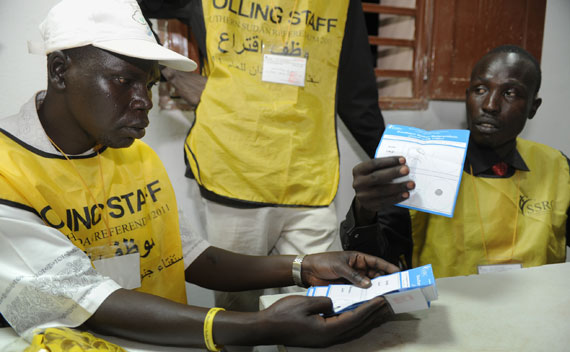 Polling center workers sort and count ballots in Aweil, Sudan. 