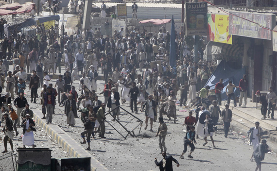 Government backers hurl rocks at anti-government protesters during clashes in Sanaa February 17, 2011. Hundreds of Yemen government loyalists wielding batons and daggers chased off a small group of protesters trying to kick off a seventh day of rallies on Thursday to demand their president end his thirty-two year rule. (Ammar Awad/ courtesy Reuters)