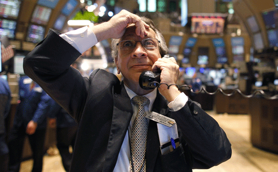 Floor trader Joe Quaglieri uses a phone on the floor of the New York Stock Exchange, April 18, 2011. Wall Street fell more than 1 percent on Monday as sovereign debt fears on both sides of the Atlantic and China’s monetary tightening hurt the outlook for global economic growth. (Brendan McDermid/courtesy Reuters)