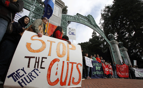 Student protestors hold signs while they block the Sather Gate at the University of California at Berkeley March 4, 2010 to protest against fee increases and budget cuts. In all, thousands of students at campuses across California were expected to protest. REUTERS/Kevin Bartram 