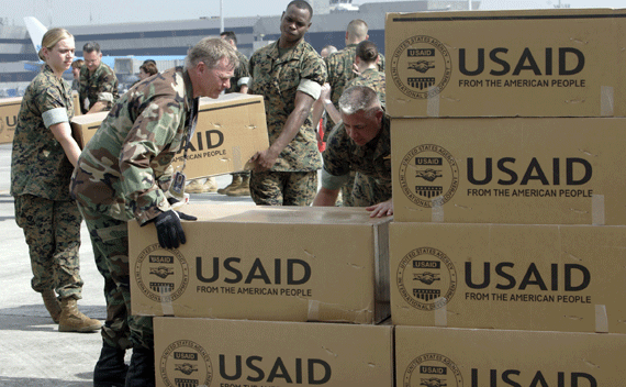 Photographer: 	 REUTERS/Romeo Ranoco American soldiers carry relief supplies for families affected by Typhoon Durian from a cargo plane after its arrival at the Manila International airport December 7, 2006. Americans, through the U.S. Agency for International Development (USAID), provided disaster relief and assistance to the Philippines after it was severely hurt by Typhoon Durian that killed 570 people and destroyed nearly 250,000 houses. REUTERS/Romeo Ranoco (PHILIPPINES)