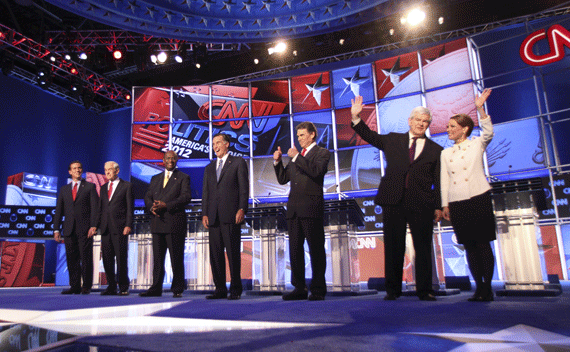 GOP presidential candidates (L-R) former Pennsylvania Senator Rick Santorum, Rep. Ron Paul (R-TX), Herman Cain, former Massachusetts Governor Mitt Romney, Texas Governor Rick Perry, former House of Representatives Speaker Newt Gingrich and Rep. Michele Bachmann (R-MN) stand on stage at the CNN Western Republican debate in Las Vegas, Nevada October 18, 2011. REUTERS/Richard Bria
