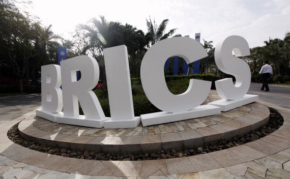 A man walks past a signage decoration for the BRICS summit outside Sheraton Hotel, the venue for the third BRICS summit in Sanya, Hainan province on April 14, 2011.