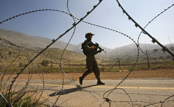 An Israeli soldier patrols along the Israeli-Syrian border near Majdal Shams in the Golan Heights (Ronen Zvulun/Courtesy Reuters)