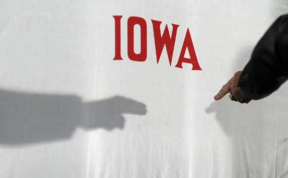 Governor Rick Perry points at the Iowa state flag during a campaign event in December, 2011 (John Gress/courtesy Reuters).