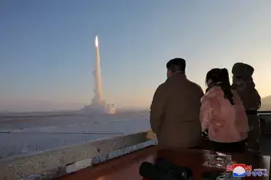 North Korean Leader Kim Jong Un views the launch of a Hwasong-18 intercontinental ballistic missile at an unknown location on December 18, 2023.
