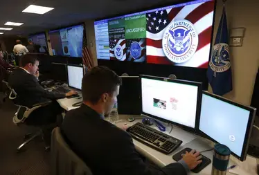 U.S. Department of Homeland Security employees work inside the National Cybersecurity and Communications Integration Center in Arlington