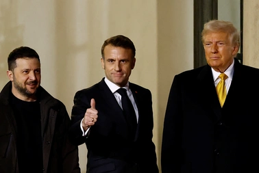 French President Emmanuel Macron accompanies U.S. President-elect Donald Trump and Ukraine's President Volodymyr Zelenskyy after a trilateral meeting at the Elysee Palace in Paris. REUTERS/Christian Hartmann