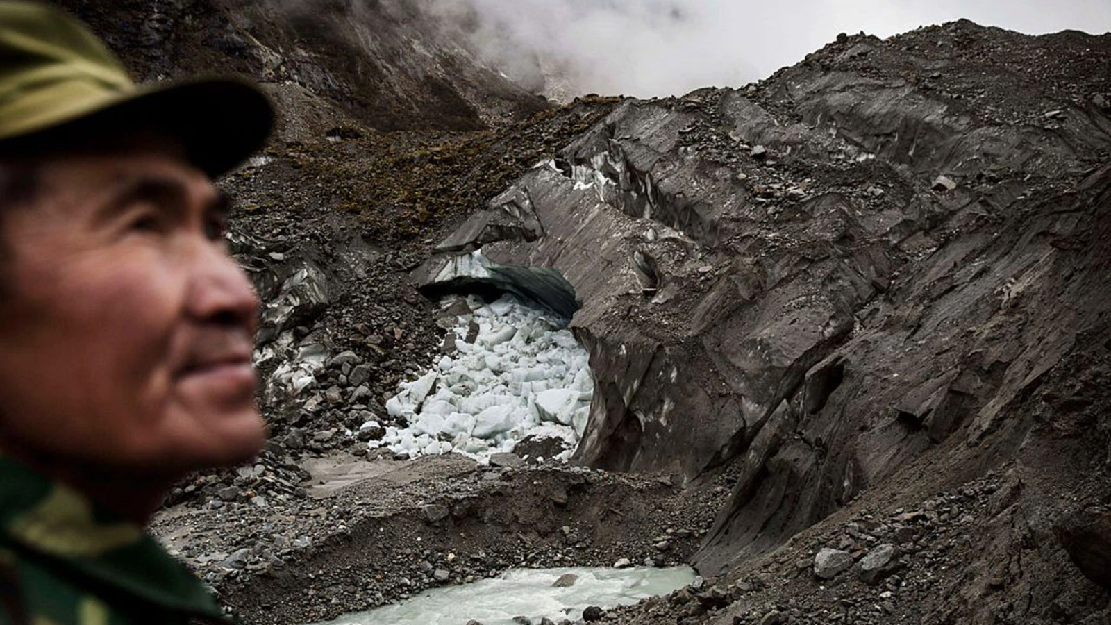 A villager stands near one of China’s monsoonal glaciers in Hailuogou, November 11, 2015.