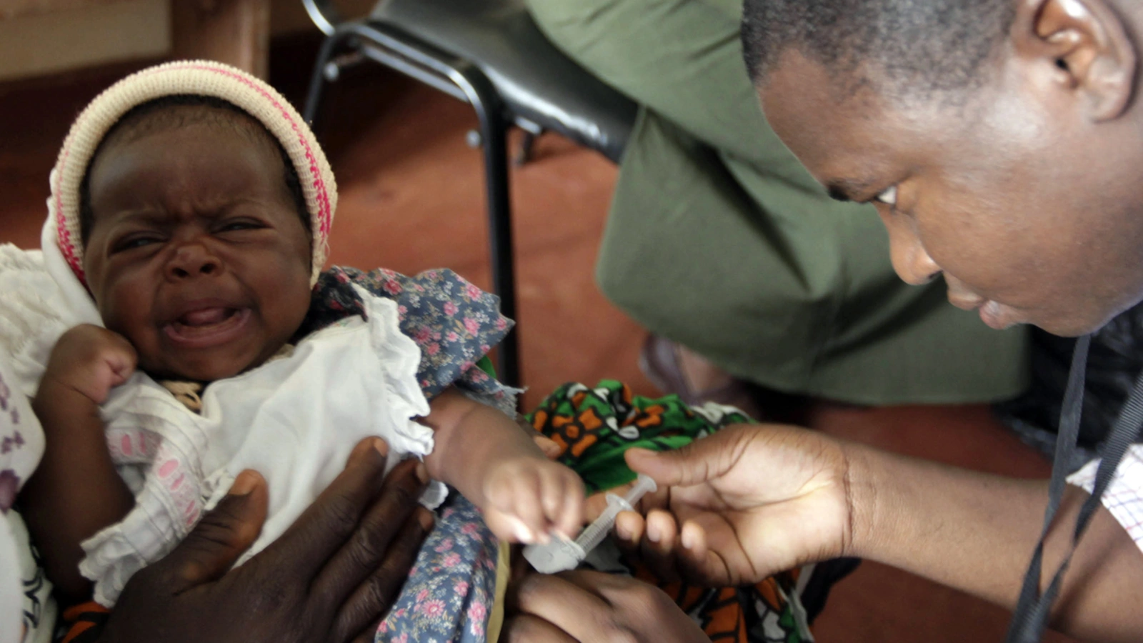 A child is given an injection as part of a malaria vaccine trial at a clinic in Kilifi, Kenya.