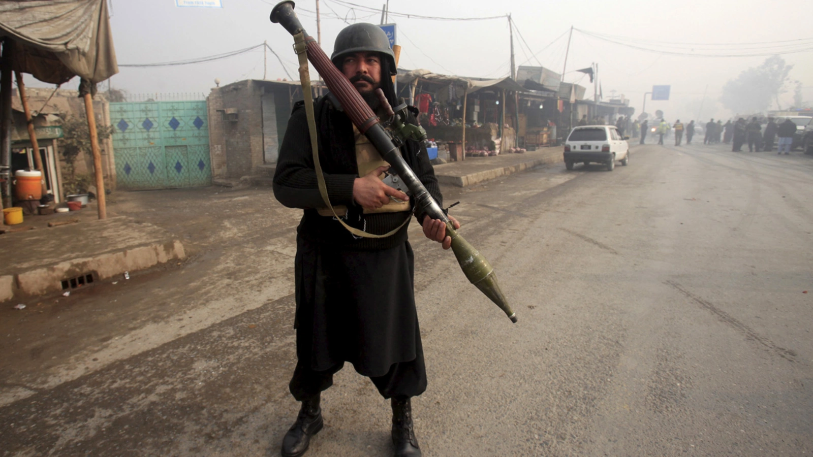 A paramilitary soldier stands guard after a suicide bomber blew himself up near a Peshawar police station. 