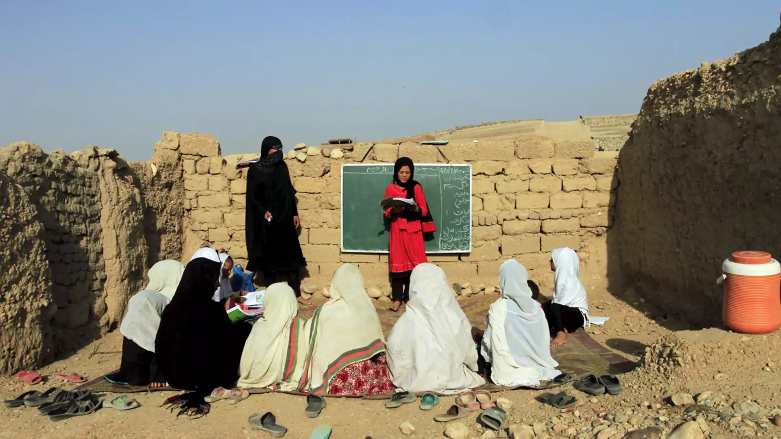 Afghan girls study at an open area, founded by Bangladesh Rural Advancement Committee (BRAC), outside Jalalabad city, Afghanistan.