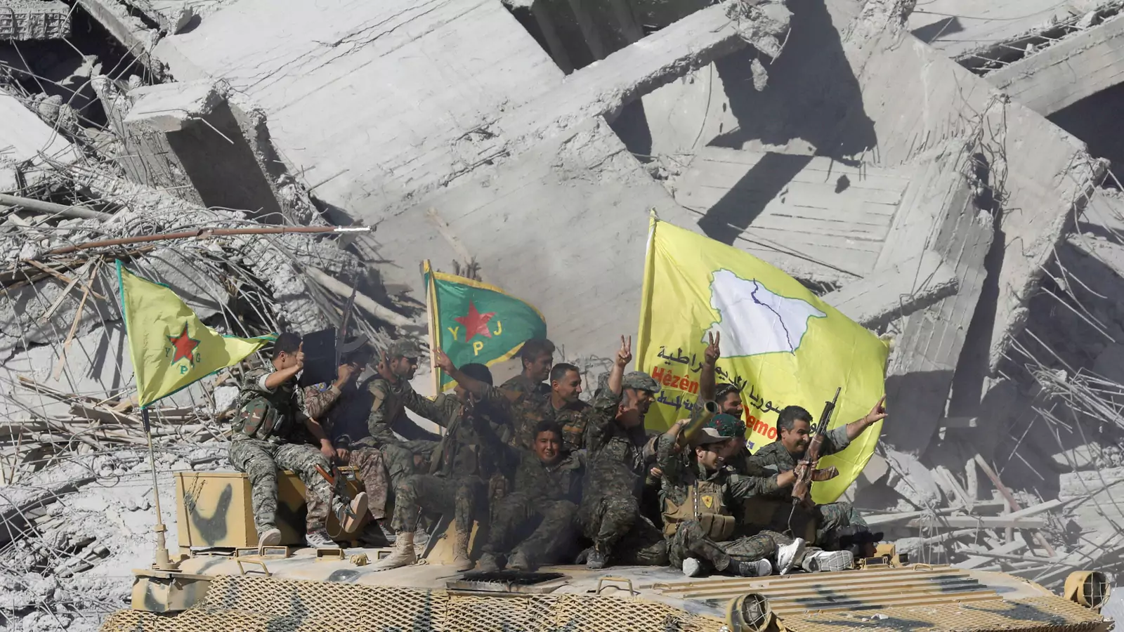 Syrian Democratic Forces fighters celebrate victory in Raqqa.