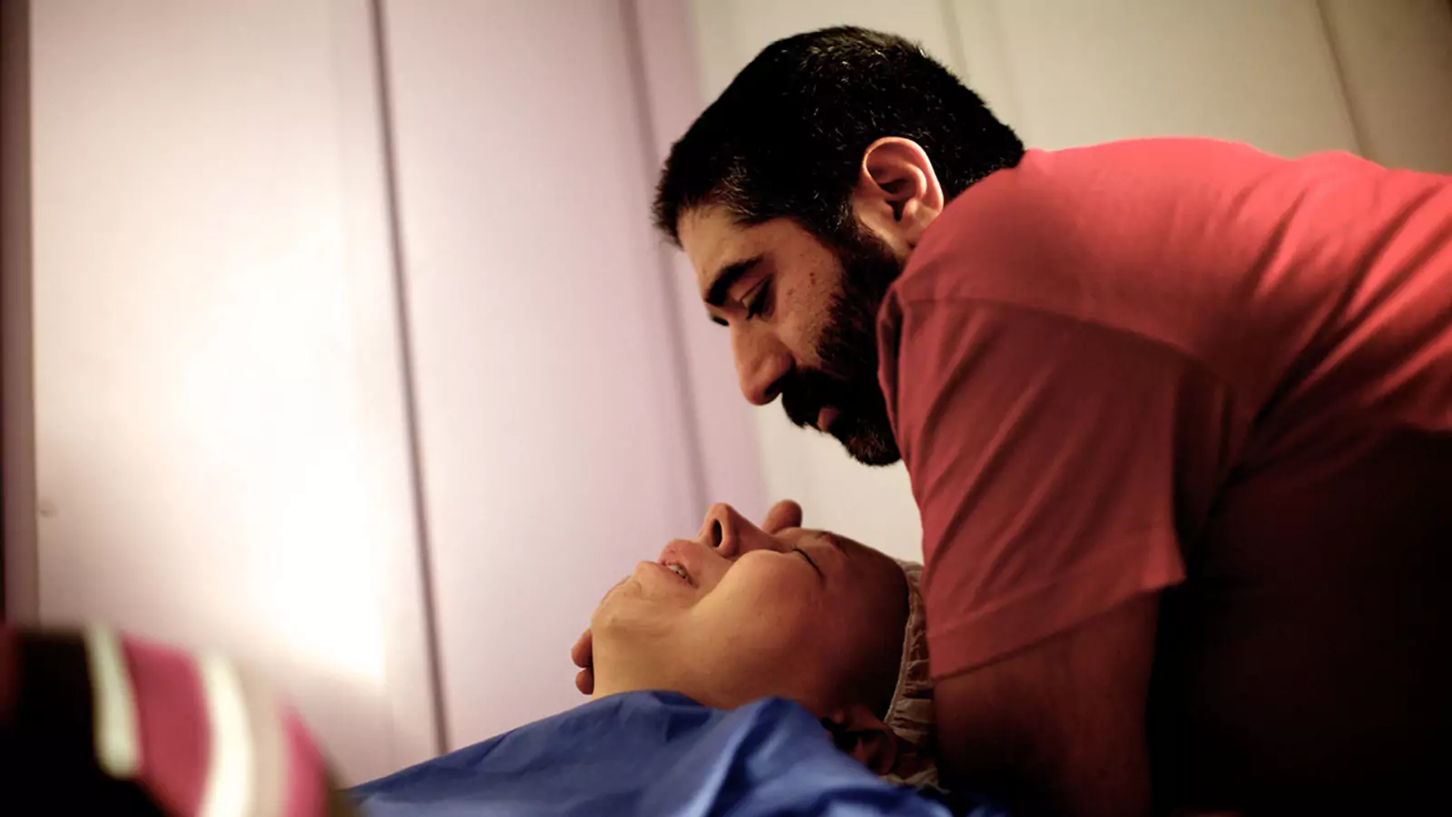 A man comforts his fiancée, a patient at a breast cancer clinic in Tehran, Iran. With little access to preventive and primary care, working-age people in poorer nations are more likely to develop and receive late diagnoses for cancers and other NCDs.
