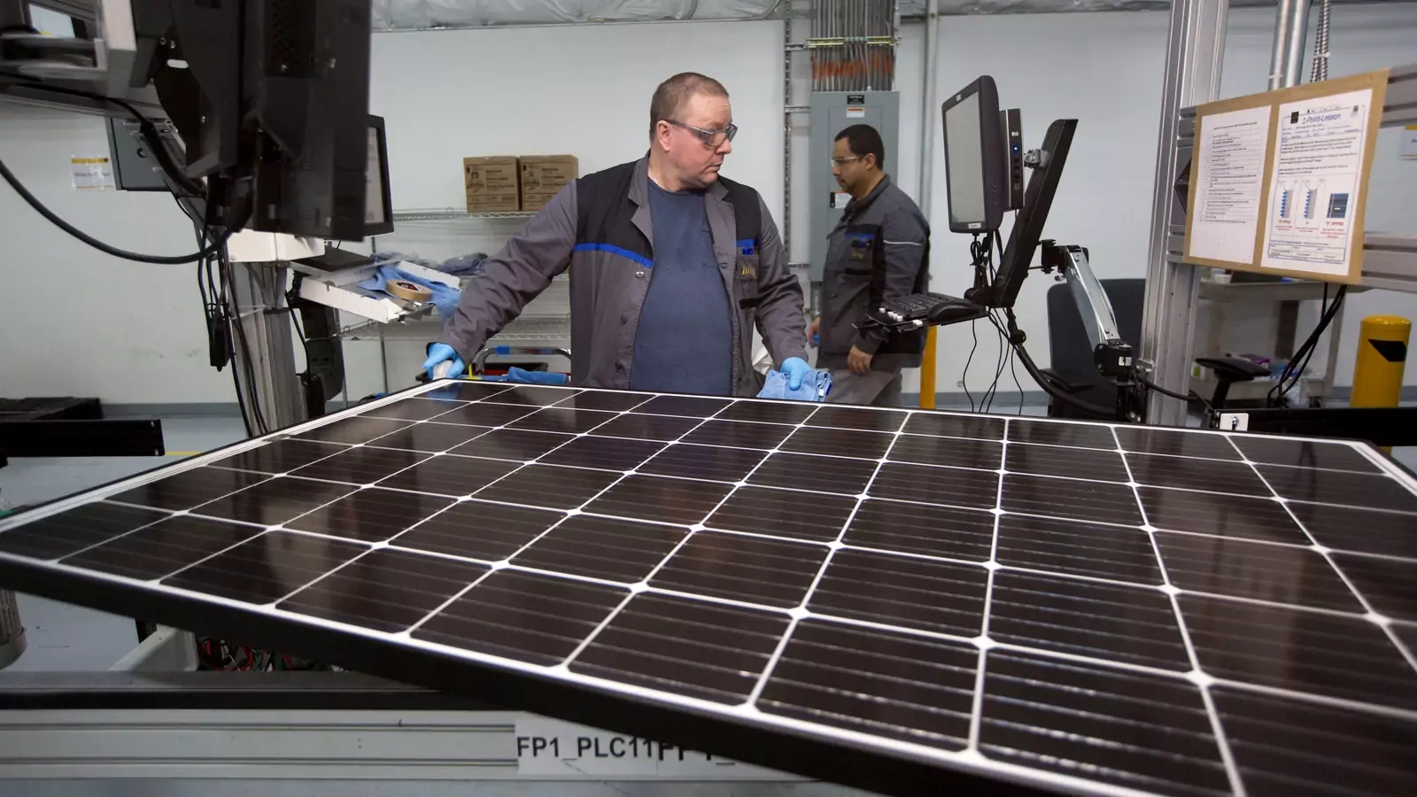 A worker checks a solar panel at a factory in Hillsboro, Oregon.