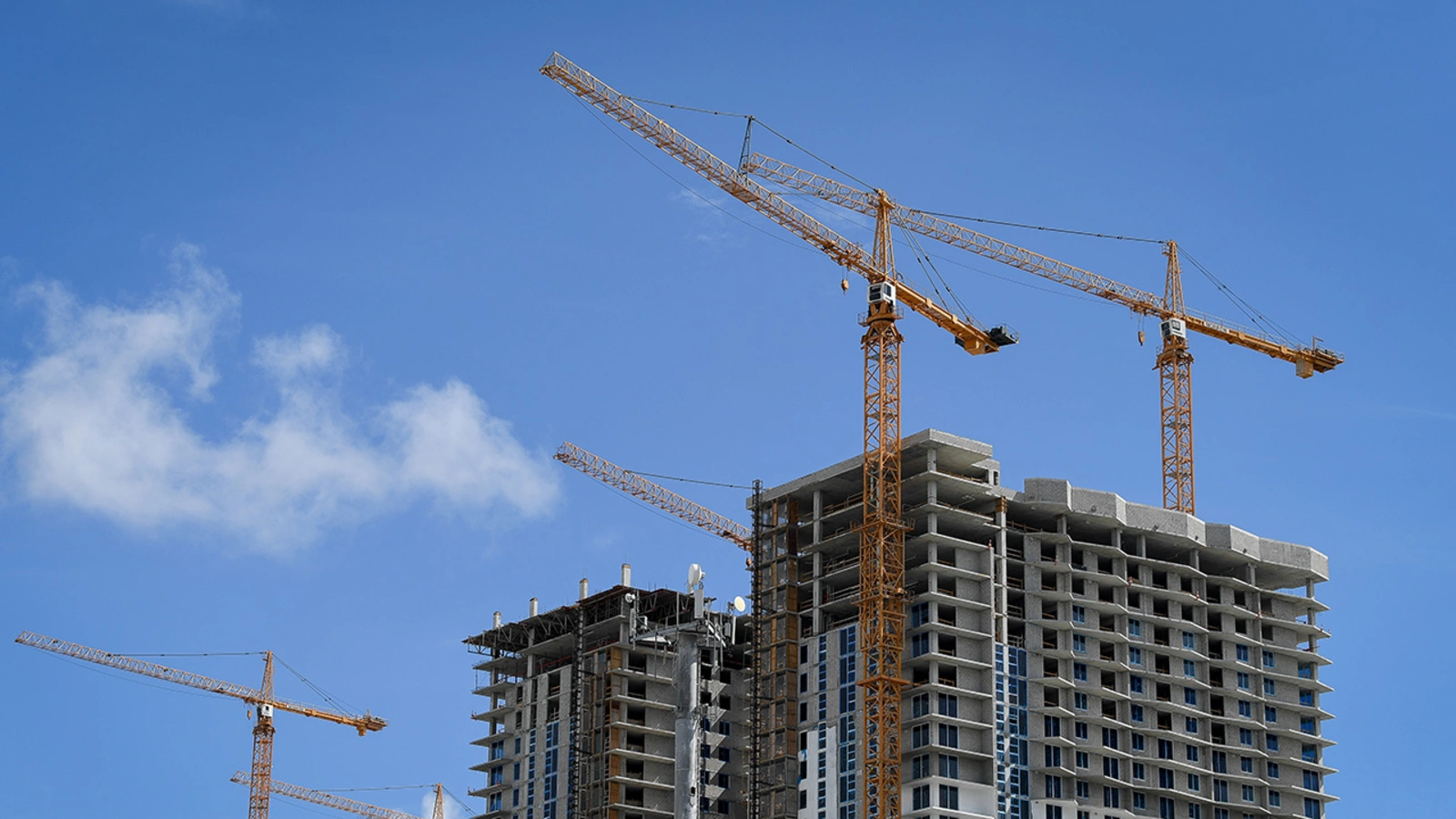 Construction towers loom above the skyline in Miami, Florida.