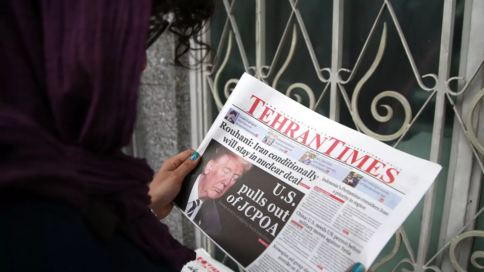 A woman reads the Tehran Times, May 9, 2018.