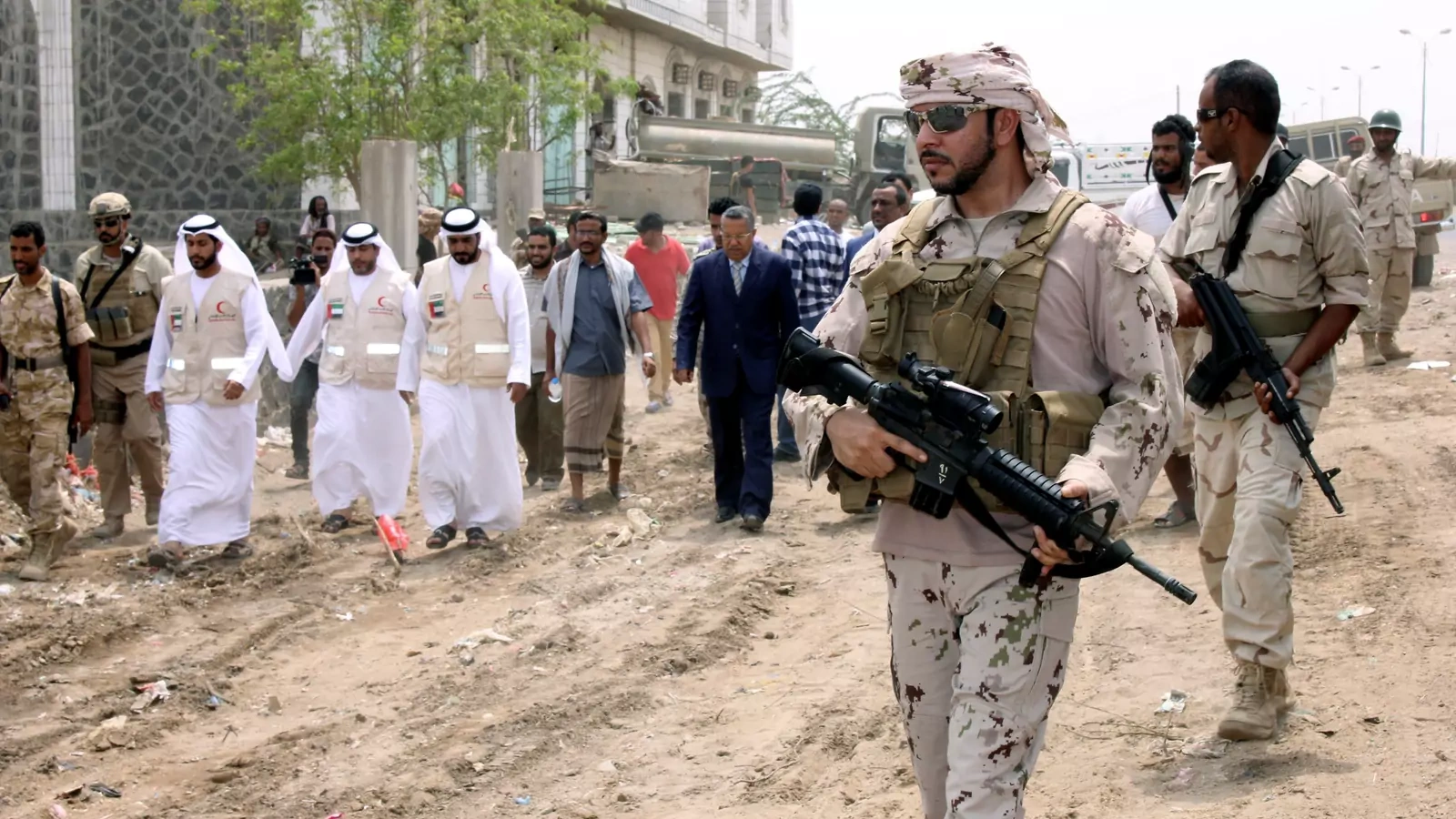 An Emirati soldier escorts Yemen's prime minister in the port city of Mukha.