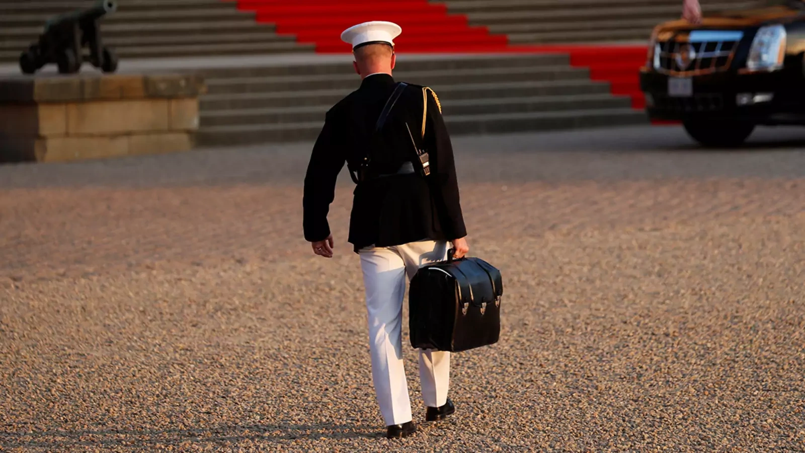 A military aide carries the "football" containing launch codes for U.S. nuclear weapons.