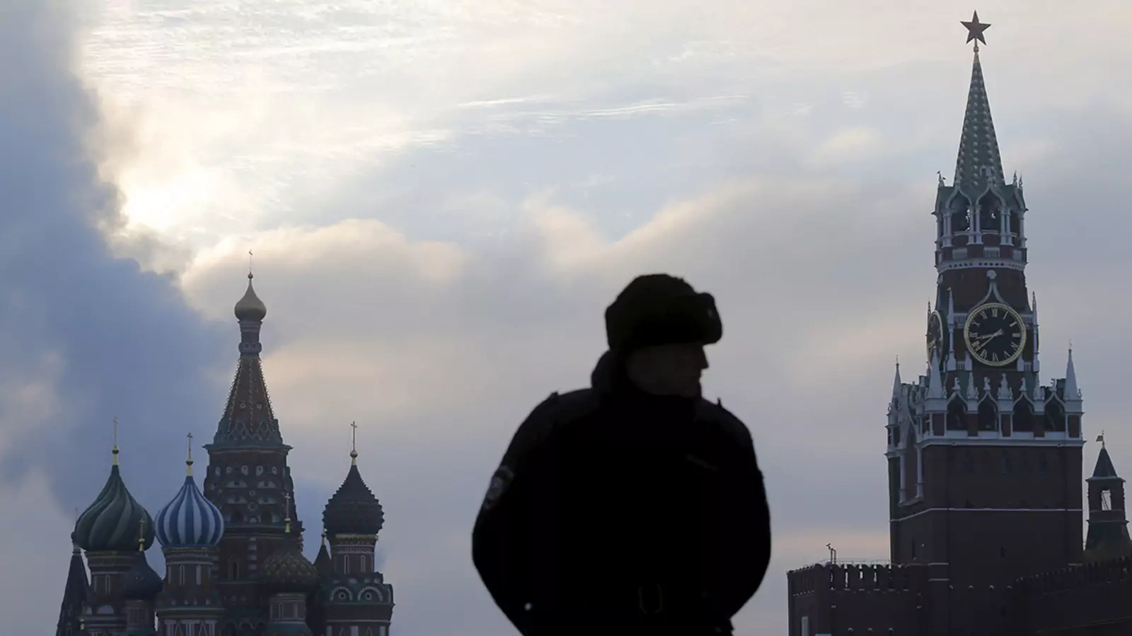 A guard stands in front of St. Basil's Cathedral and the Kremlin in Moscow, the centers of political and religious authority in Russia for much of the past several centuries.