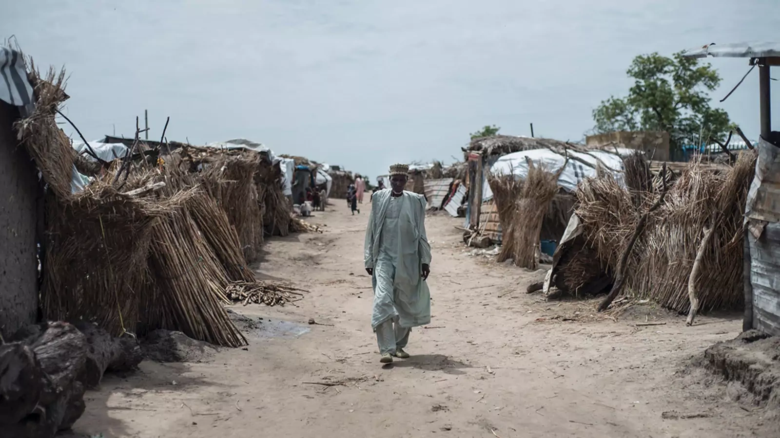 A man walks through a camp for internally displaced people in Rann, Nigeria.