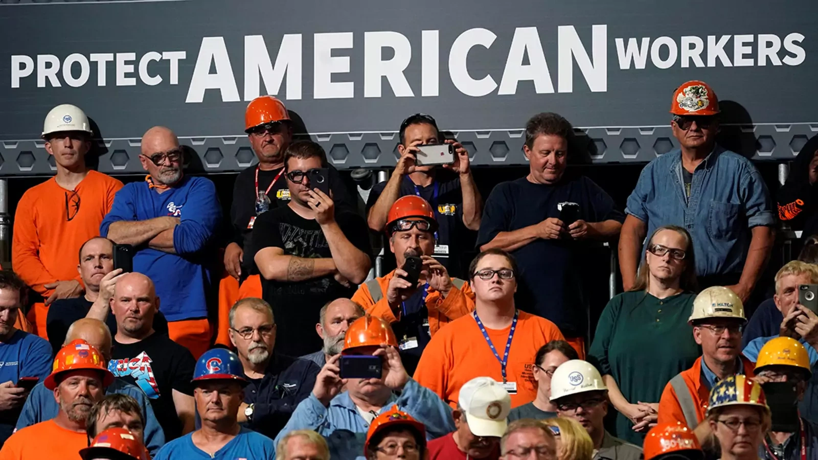 Steelworkers watch President Donald J. Trump speak about trade policy at a steel plant in Granite City, Illinois, on July 26, 2018.