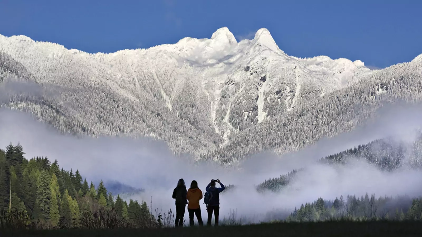 Visitors explore the mountains of British Columbia, near Canada's Pacific coast, in 2012.