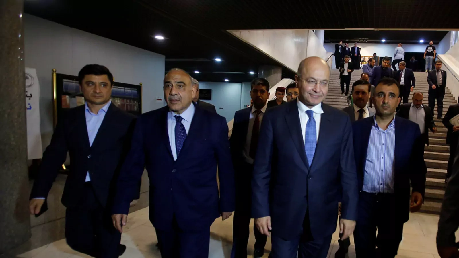 Barham Salih, Iraq's new president, walks with new Prime Minister Adel Abdul-Mahdi at the parliament headquarters in Baghdad.
