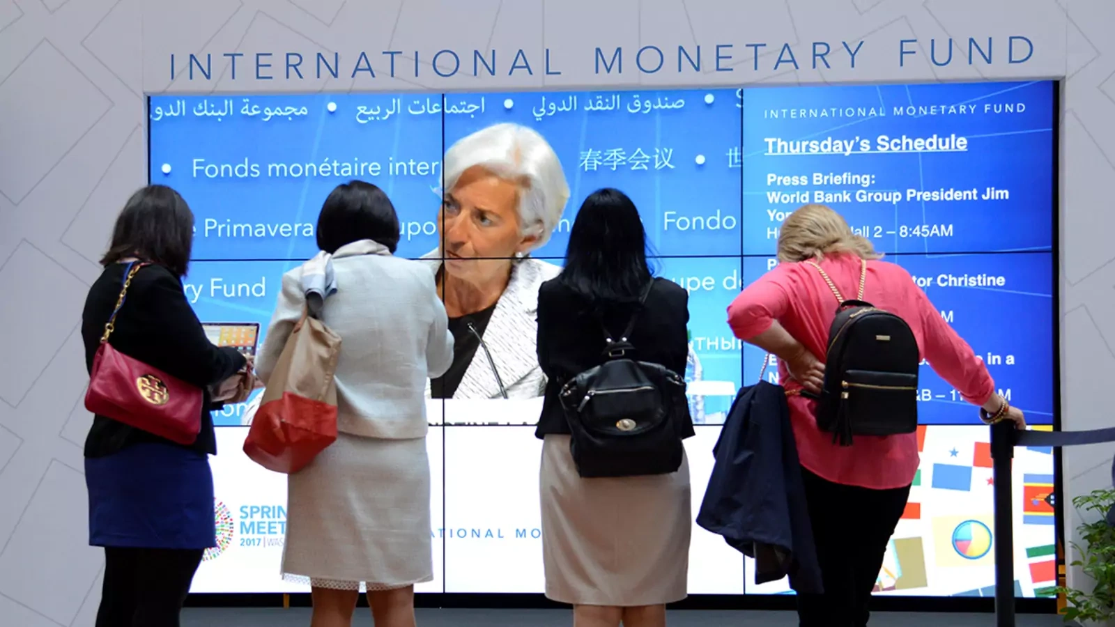 Visitors watch IMF Managing Director Christine Lagarde during the opening of the IMF and World Bank Annual Spring Meetings in Washington, DC, in 2017.