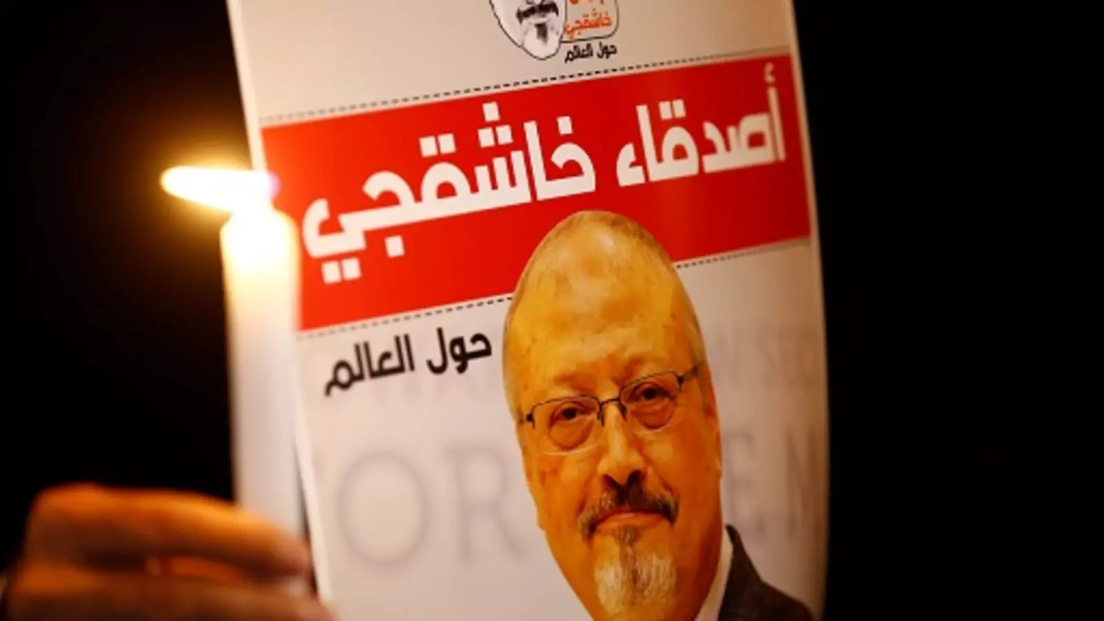 A demonstrator holds a poster with a picture of Saudi journalist Jamal Khashoggi. 